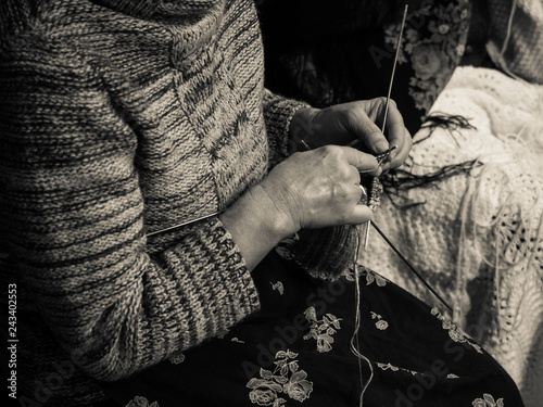 Detail of an old lady knitting.