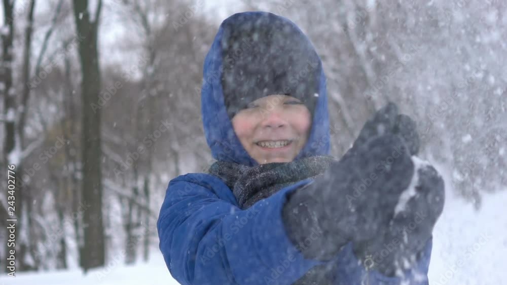 portrait of a young guy clapping hand with snow in the winter forest portrait of a young guy clapping hand with snow in the winter forest