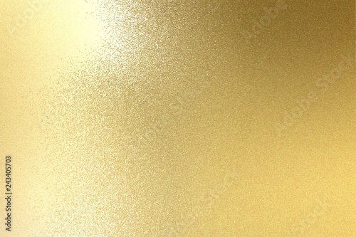 Light shining on brushed gold metal plate texture, abstract background
