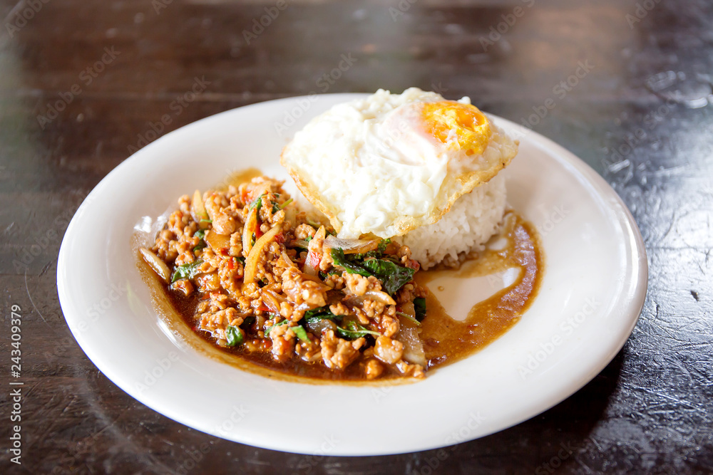 Rice topped with stir-fried minced pork and basil with Fried egg Rice topped with stir-fried minced pork and basil with Fried egg