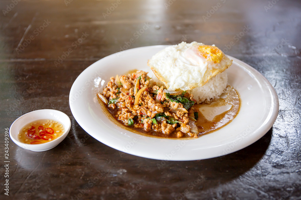 Rice topped with stir-fried minced pork and basil with Fried egg Rice topped with stir-fried minced pork and basil with Fried egg