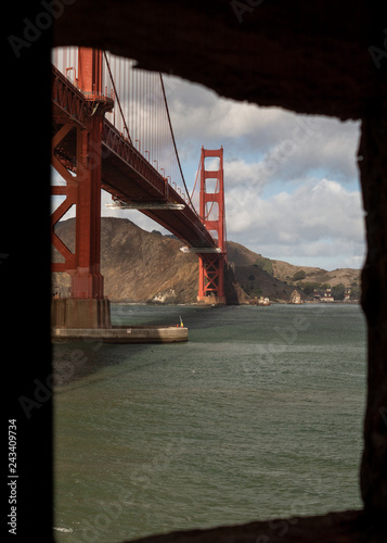  Golden Gate bridge from the window of Fort Point on a partly cloudy day 