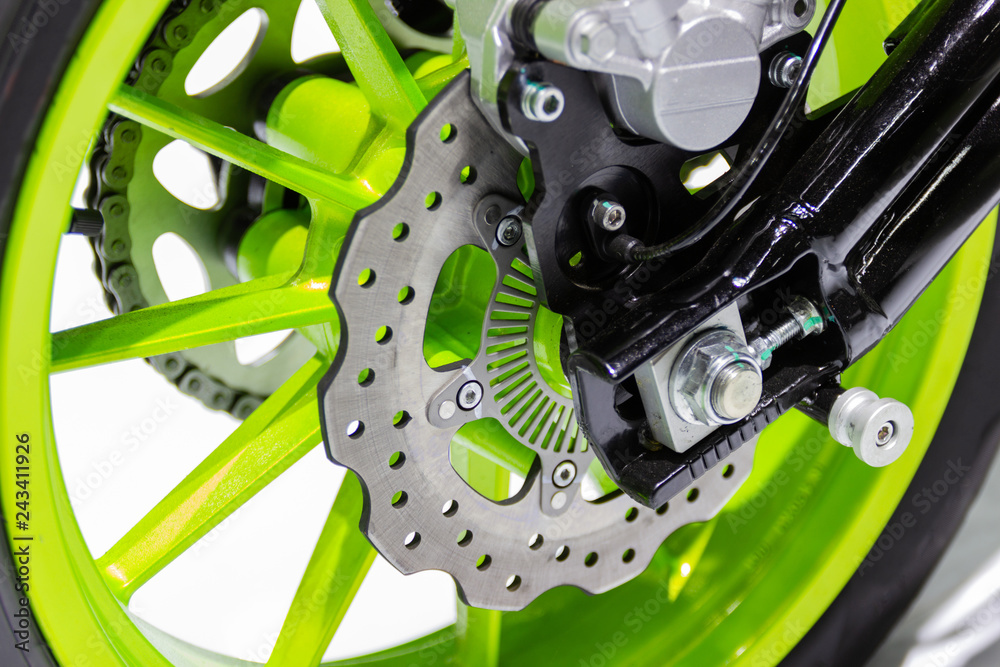 Obraz premium Detail Motorcycle wheel in black and green with ABS brakes part of the motorcycle.