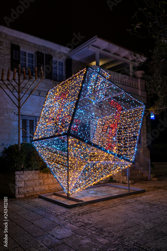 Big Savivon of luminous bulbs for the holiday of Hanukkah in Haifa, Israel. Holiday decorations on Ben Gurion Street in Haifa for Hanukkah and Christmas. decoration, Haifa, Israel, Hanukkah, Christmas