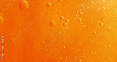 Extreme macro of bubbles in orange gel. 4K.