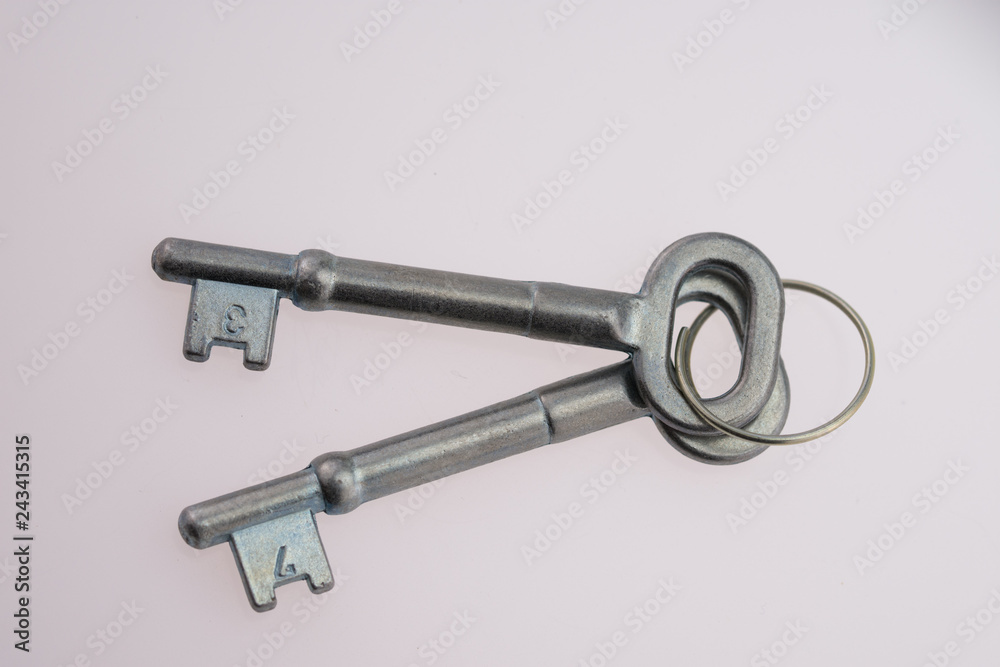 An Old-Fashioned Key on a White Background An Old-Fashioned Key on a White Background
