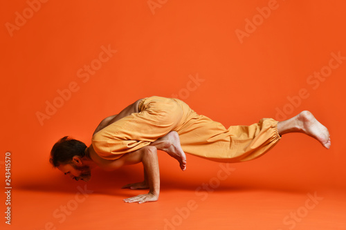 Sporty senior man doing Arm balance exercise for strength, yoga, pilates training, photo