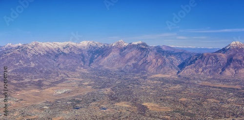 Aerial view of Wasatch Front Rocky Mountain landscapes on flight over Colorado and Utah during winter. Grand sweeping views near the Great Salt Lake, Utah Lake, Provo, Timpanogos, Lone and Twin Peaks 