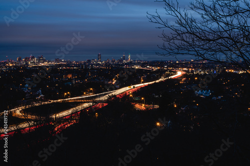 Light trails leading to the city at night