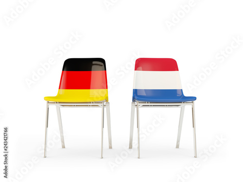Two chairs with flags of germany and netherlands isolated on white