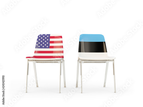 Two chairs with flags of US and estonia isolated on white