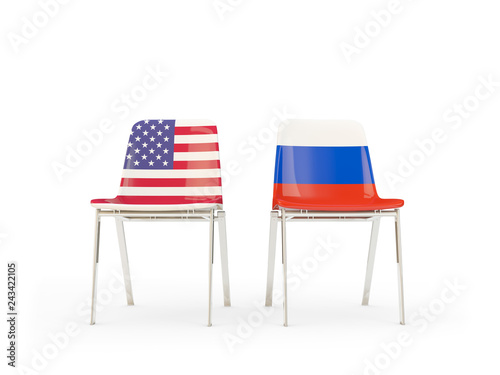 Two chairs with flags of US and russia isolated on white