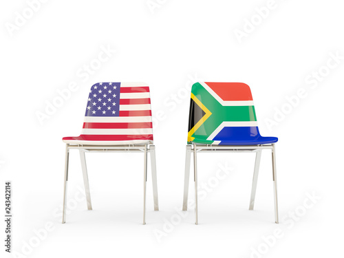 Two chairs with flags of US and south africa isolated on white