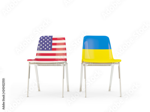 Two chairs with flags of US and ukraine isolated on white