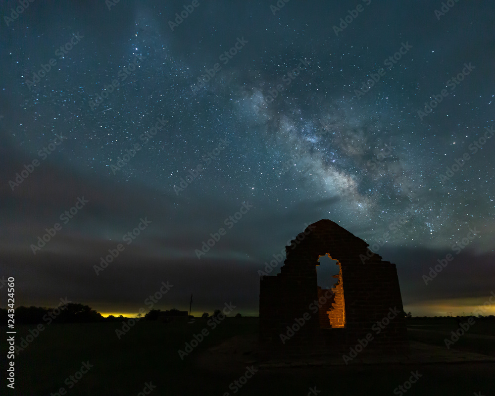milky way over abandoned building at fort griffin historical site.
