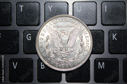 United States of America coin one silver dollar on the keyboard. US Morgan silver dollar coin 1921