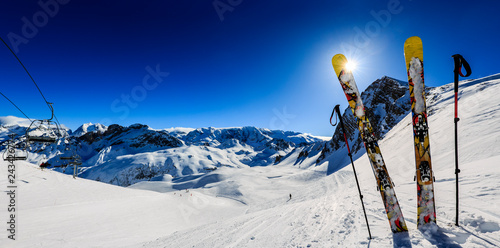 Fotografie, Obraz Ski in winter season, mountains and ski touring equipments on the top in sunny day in France, Alps above the clouds