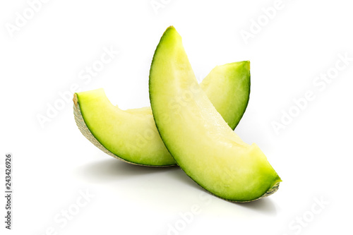 Green melon slices isolated on white background.