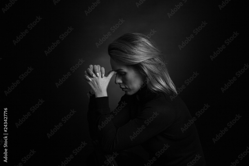 Dramatic black and white portrait of a beautiful woman on a dark background Dramatic black and white portrait of a beautiful woman on a dark background