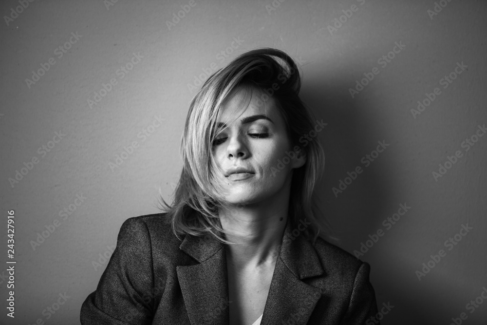 Dramatic black and white portrait of a beautiful woman on a dark background