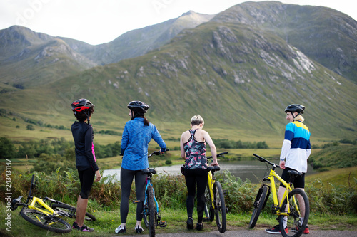 Group of cyclists by the riverside in the Highlands photo