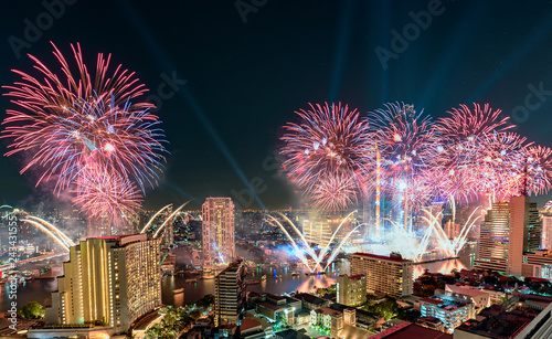 Celebration of New year day with colorful fireworks on Chao Phraya riverside with Iconsiam building landmark of Bangkok
