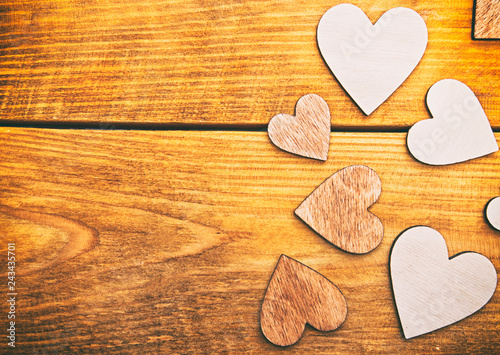 Four wooden hearts on the wooden table