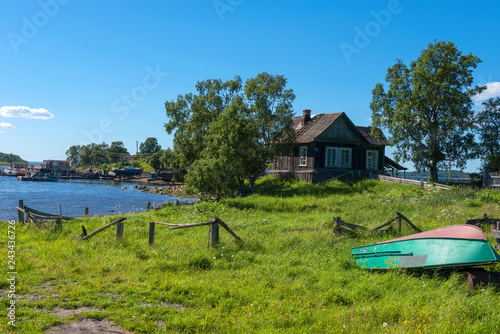 ISLAND SOLOVKI, RUSSIA - JUNE 26, 2018: View of houses in the village of Solovki on a polar summer day, at sunset.  Arkhangelsk region, White Sea