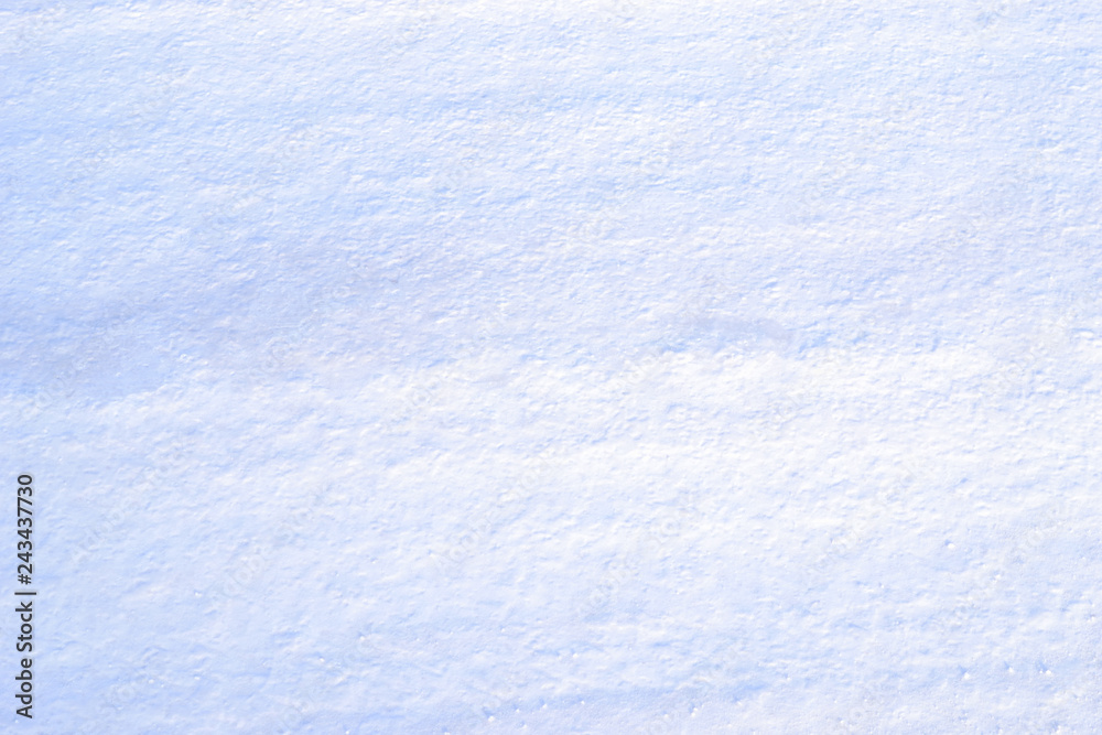 Dense snow on a rural road. Texture, background.
The snow on the road is rammed with wheels of cars.