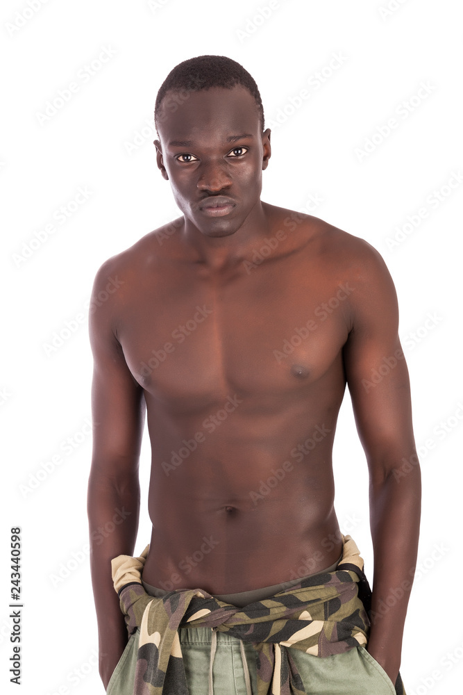 Young buff Sudanese man with a naked torso in khaki trousers looking to  camera with peircing eye contact, Stock-foto | Adobe Stock