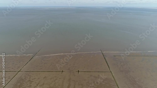 Aerial view of Wadden Sea is an intertidal zone in the southeastern part of the Northsea forming a shallow body of water with tidal flats and wetlands and is on the UNESCOs World Heritage List 4k photo