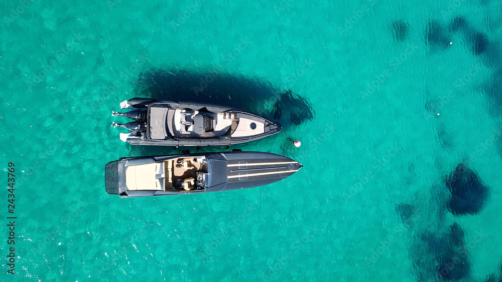 Aerial drone photo of speedboats docked in popular beach of Paradise, Mykonos island, Cyclades, Greece Aerial drone photo of speedboats docked in popular beach of Paradise, Mykonos island, Cyclades, Greece