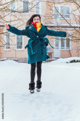 Hispanic happy woman jumping and having fun outdoor. Good mood, winter nice time 