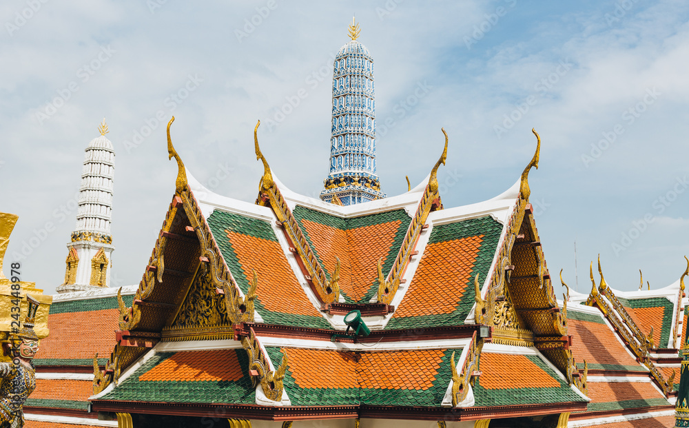 Fototapeta premium The beauty of the Emerald Buddha Temple . And while the gold of the temple catching the light. This is an important buddhist temple of thailand and a famous tourist destination.