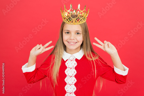 Childhood happiness. happy little girl on red background. small girl child. School education. family and love. childrens day. Good parenting. Child care. littlle queen in crown. Just look at this. photo