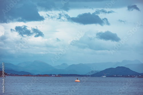 Island on the horizon. Beautiful sea landscape in evening. Nature of Norway. Seascape