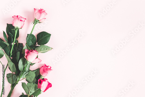 Flowers composition. Pink rose flowers on pastel pink background. Flat lay, top view, copy space
