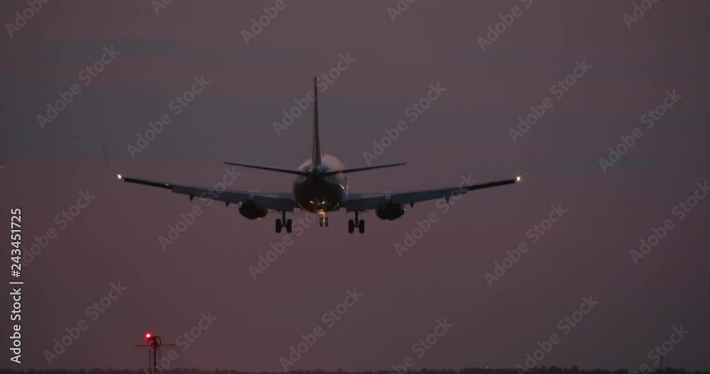 4K - Airplane landing at night on airport runway 4K - Airplane landing at night on airport runway