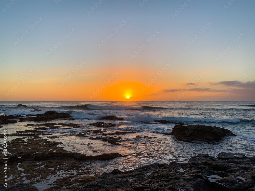 Sunset over the Atlantic ocean and stony coast of Fuerteventura