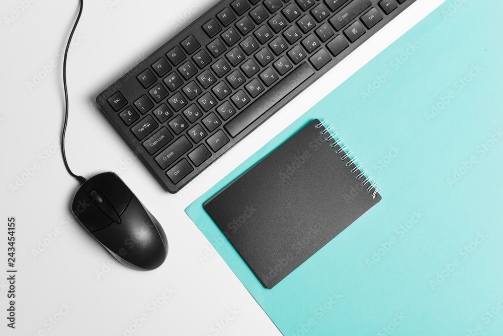 Computer keyboard and mouse on color block background, office interior Computer keyboard and mouse on color block background, office interior