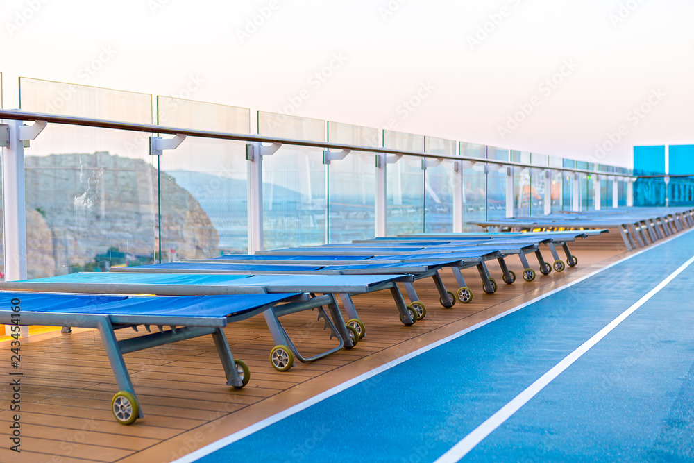 Fototapeta premium Lounge chairs on deck of cruise ship