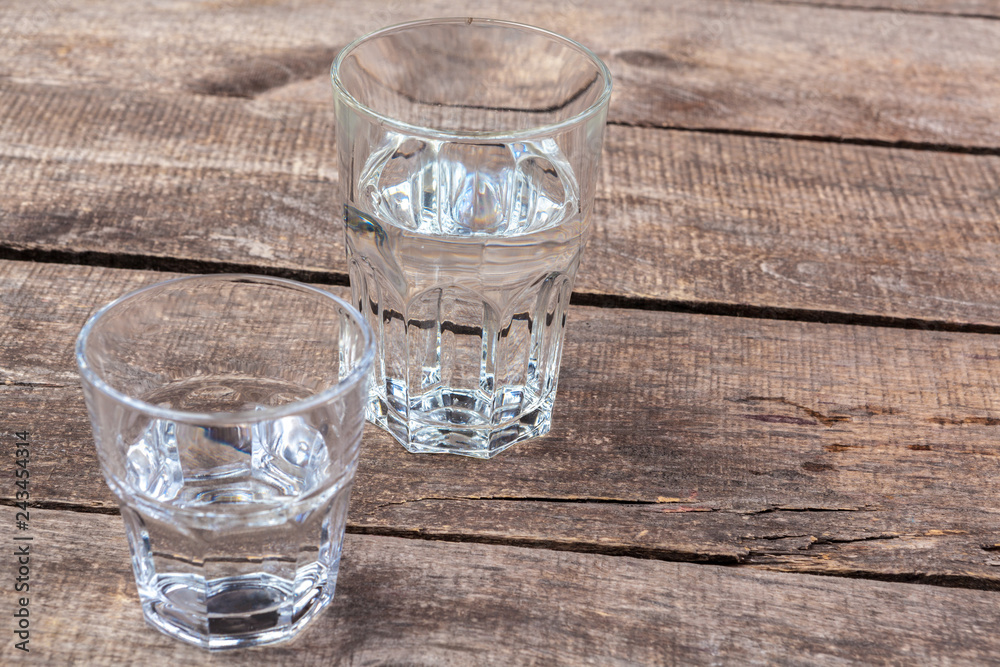 Glasses of water on a wooden table. Glasses of water on a wooden table.