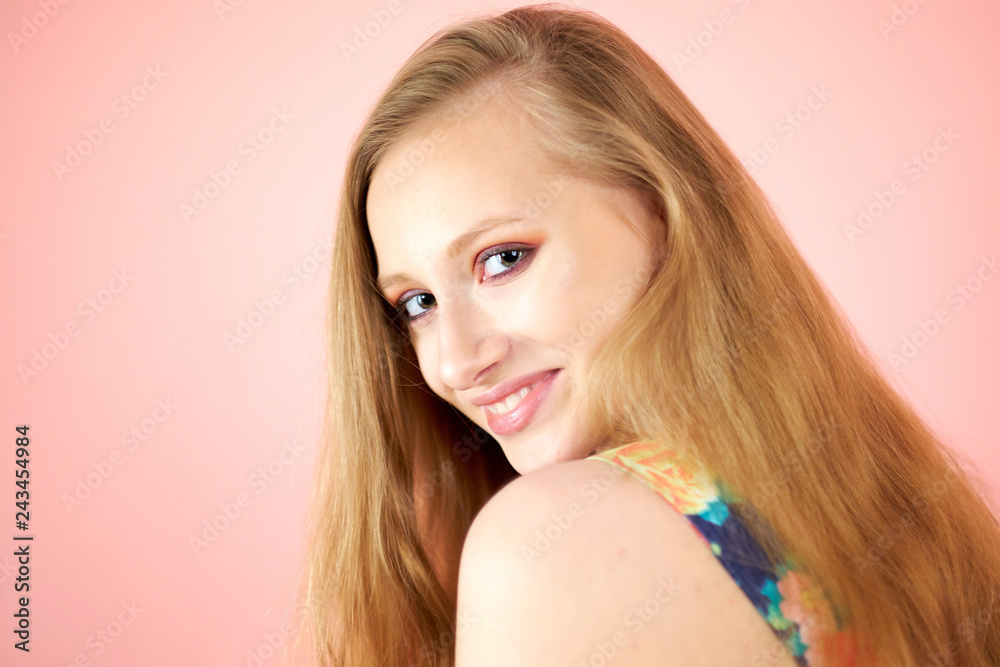A bright girl isolated on a pink background A bright girl isolated on a pink background