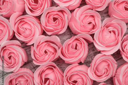 Pink roses on the wooden background