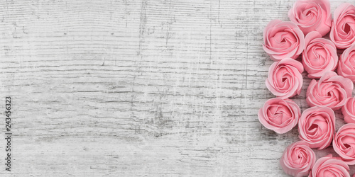Pink roses on the wooden background