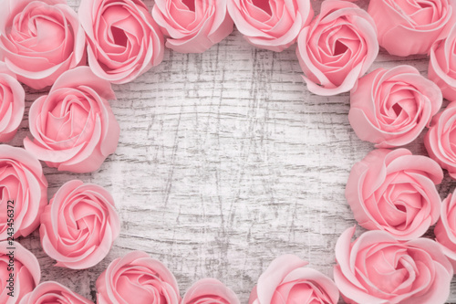 Pink roses on the wooden background photo