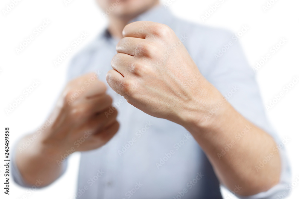 Obraz premium Man raised his fists ready to fight, isolated on white background
