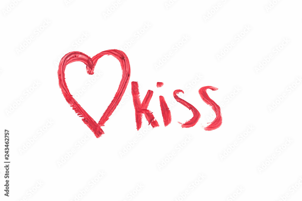 Heart and word kiss drawn with color lipstick isolated on white.