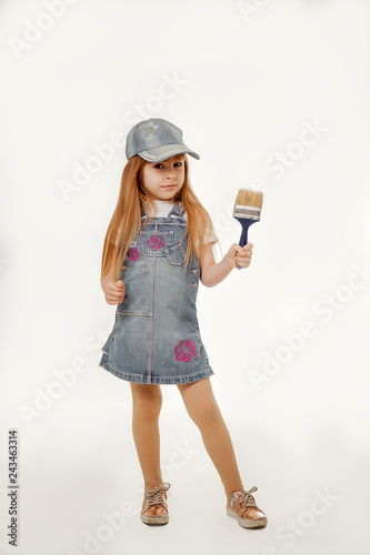 Little painter. Adorable girl with a paint brush . Isolated on white background