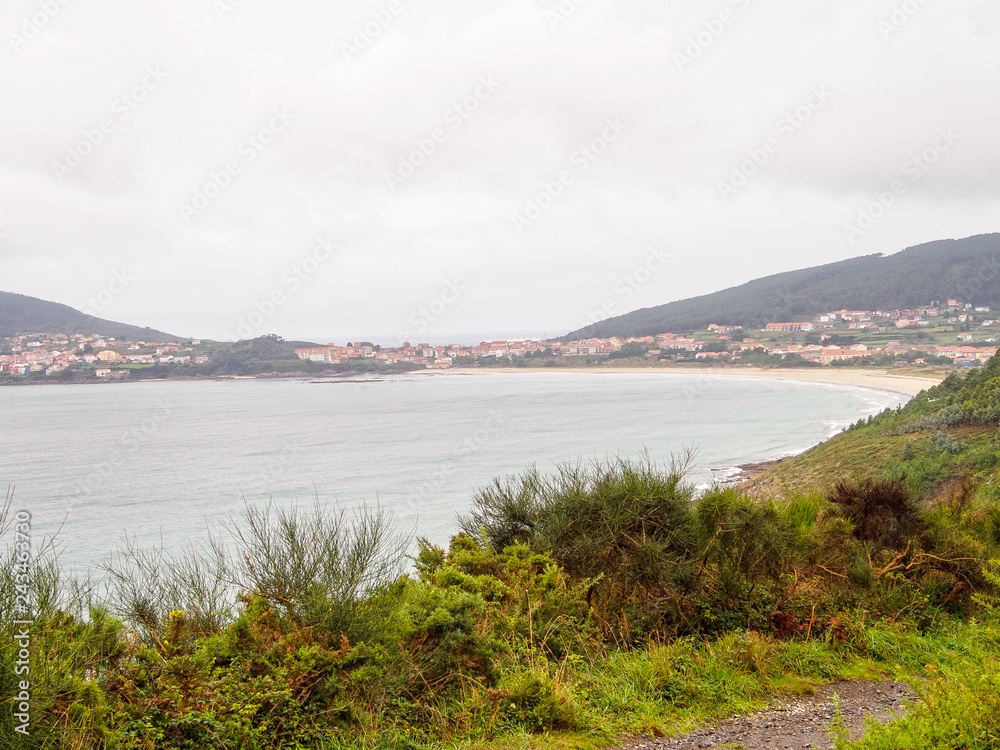 First sight of Finisterre and the Shrimp Beach Praiade Langosteira on an overcast day in autumn - Sardineiro, Galicia, Spain